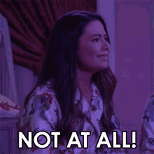 a woman in pajamas says not at all in a purple room .