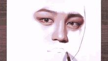 a person is drawing a picture of a man 's face with a pencil .