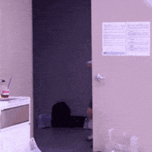 a bottle of coke sits on a table next to a doorway