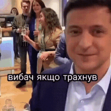 a man in a suit is standing in front of a group of people with a caption that says ' vibach ' on it
