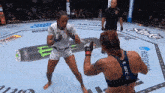 two women are fighting in a ring with bud light advertisements on the wall
