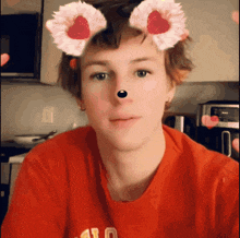 a young man wearing a red shirt with the letter a on the front