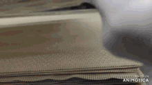 a close up of a stack of paper with the words made in animatica on the bottom