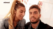 a man and a woman are looking at each other and making funny faces .