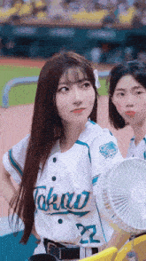a girl wearing a baseball uniform with the number 22 on it