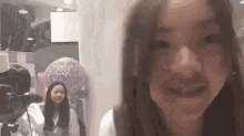 a girl is making a funny face in front of a camera .