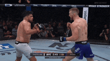 two men are fighting in a boxing ring with the ufc logo on the bottom