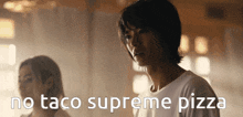 a man standing next to a woman with the words no taco supreme pizza written below him