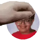 a close up of a person 's face with glasses and a red shirt .