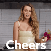 a woman in a white dress is holding flowers and cheers