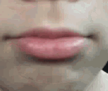 a close up of a person 's lips with pink lipstick on them .