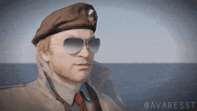 a man wearing a beret and sunglasses is standing in front of a body of water with the words @awaresst below him
