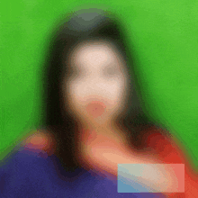 a blurry picture of a woman 's face is against a green background .