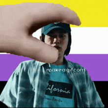 a man wearing a california ocean pacific shirt is being touched by someone 's hand