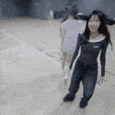 two girls are walking on a wooden floor with the letters ak written on the floor