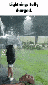 a person is standing in front of a waterfall with lightning coming from it