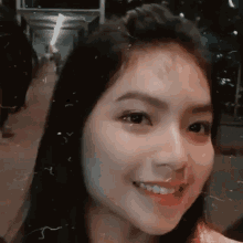 a close up of a woman 's face with a blurred background .