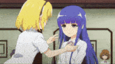 a girl with purple hair is touching another girl 's neck