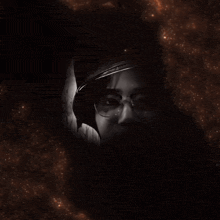 a man wearing a helmet and glasses looks at the camera