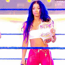 a woman with blue hair is holding a championship belt that says boss