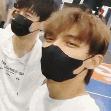 two young men wearing face masks and one has a shirt that says ' earl o'huob oh ' on it