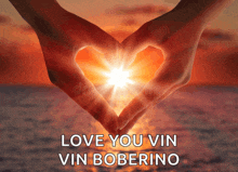 a couple of hands making a heart shape with the words love you vin vin boberino