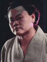 a close up of a man 's face in a kimono