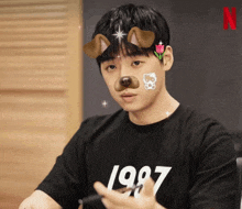 a man wearing a black shirt that says 1987 on it