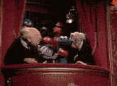 a group of sesame street characters are gathered around a man