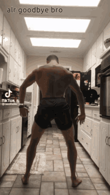 a man without a shirt is standing in a kitchen with the caption " alr goodbye bro " on the bottom