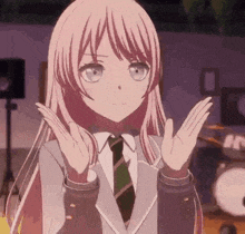 a girl with long pink hair and a tie is making a funny face .