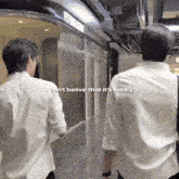 two men walking in a hallway with the words " i can 't belive that it 's finally "