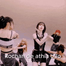 a group of women are dancing in a room with the words kochan de athia 030 written on the bottom .