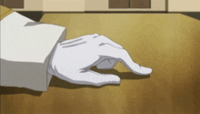 a person wearing a white glove is laying on a table