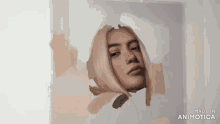 a person is painting a woman 's face with a brush