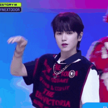a young man is wearing a shirt that says the victoria on it