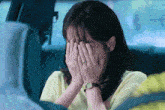 a woman with a watch on her wrist covering her face