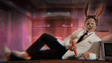a man in a suit and tie has a rabbit face on his face