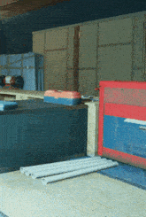 a red and blue box is sitting on a wooden table