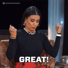 a woman sitting in a chair with her hands in the air says great