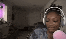 a woman wearing headphones is sitting in a chair in a living room .