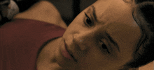 a man with a tattoo on his chest is laying on the floor