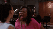 two cheerleaders wearing wmhs uniforms are dancing in a room