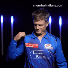 a man wearing a blue shirt that says lauriz knudsen
