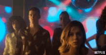 a group of people standing in front of a disco ball with netflix written on the bottom