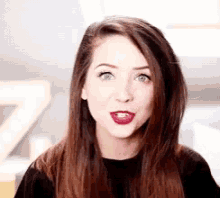 a close up of a woman 's face with long hair and red lipstick .