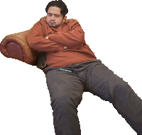 a man laying on a couch with his arms crossed and the word supreme on his pants