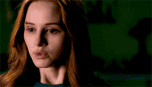 a close up of a woman with red hair making a funny face