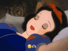 snow white from snow white and the seven dwarfs is sleeping in a bed with her eyes closed .