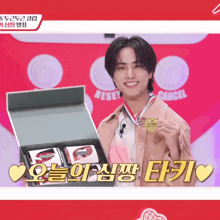 a young man is holding a medal in front of a box that says " cancel "